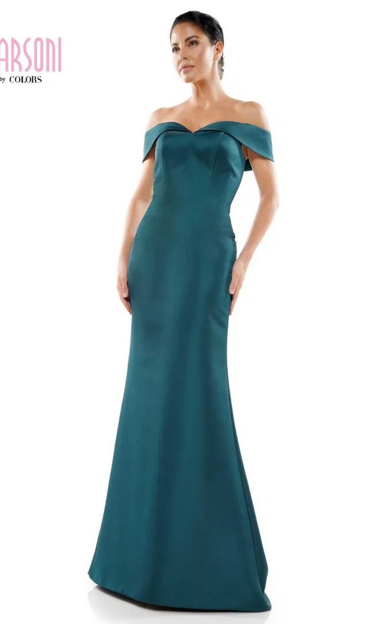 A woman stands against a plain white background wearing the Marsoni MV1153 long formal dress in deep green, featuring an off-the-shoulder design, fitted bodice, and slightly flared hem.